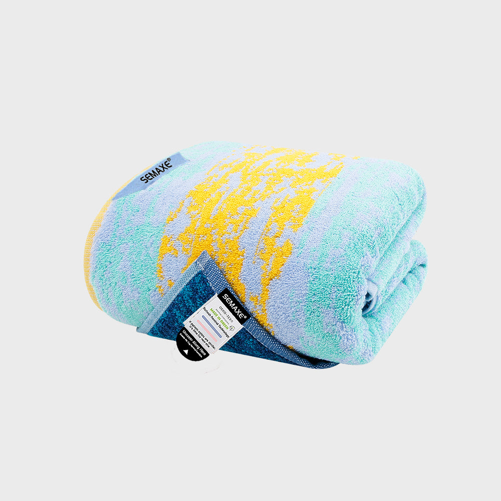 The SEMAXE Starry Sky Bath Towel envelops you in the serene hues of a clear, starlit sky. Featuring a delightful blend of celestial blue and gentle pastel yellow, this towel is designed to evoke the peace and vastness of the night sky. Each strand is crafted from high-quality cotton, ensuring optimal absorbency and a soft caress that pampers your skin after every bath, transforming your daily routine into a moment of cosmic retreat.