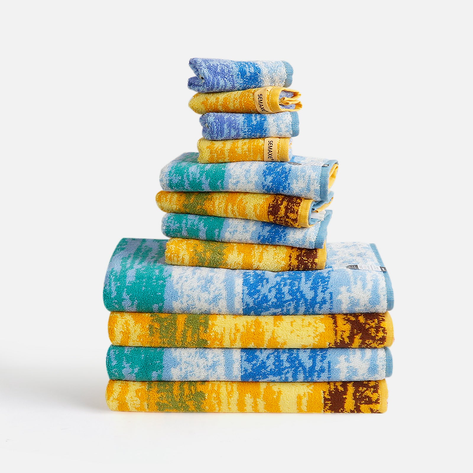 The 12-piece towel set is neatly arranged on a flat surface with rich artistic patterns on the towels