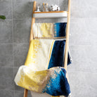 The beach towel set is folded and hung on a shelf, with rich and bright patterns