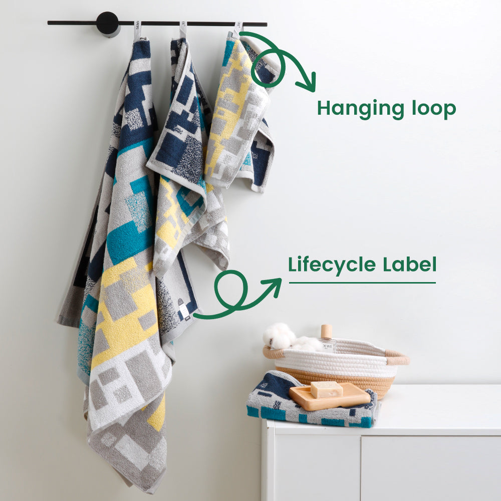 Bath towels, hand towels, and washcloths from the Impression collection are hung on towel rails to showcase their unique loops and lifecycle labels