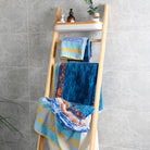 "Starry Night" hand towels and bath towels are placed on the towel rack in the bathroom, showing the artistic pattern on the front and back