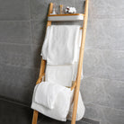 Snow-white towels hang on shelves