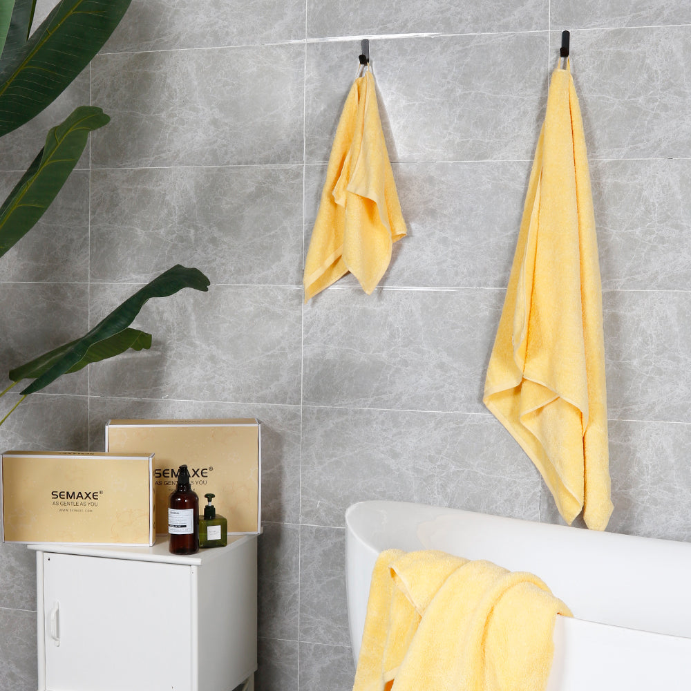 The walls of modern bathrooms are hung with yellow bath towels and hand towels