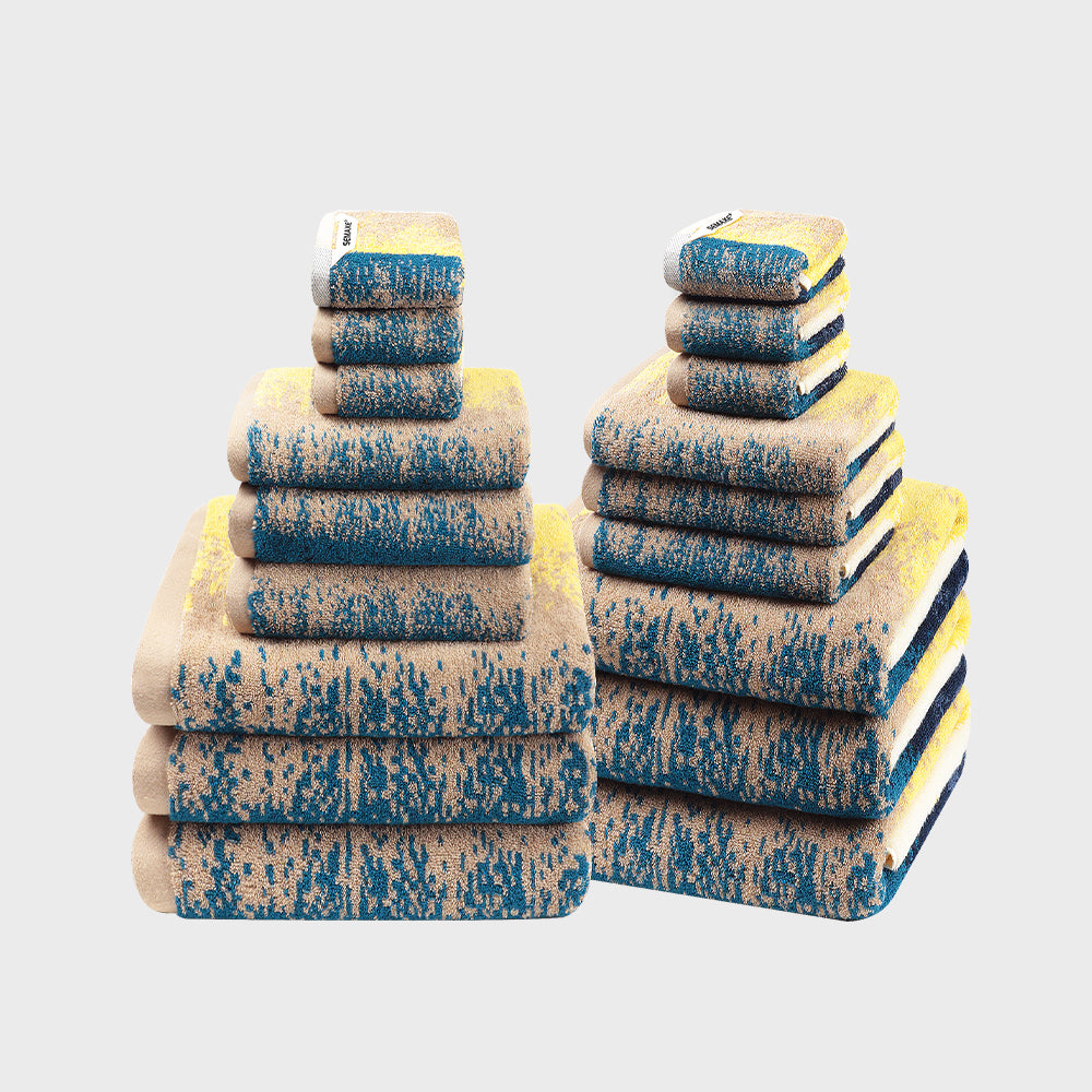 The SEMAXE Beach 18-Piece Towel Set features six bath towels (70cm x 140cm), six hand towels (40cm x 70cm), and six washcloths (35cm x 35cm), all designed for comfort and durability. Made from 100% cotton, each towel boasts strong water absorption and a plush texture. The set's aesthetic combines sandy beige and deep ocean blue, evoking the calm and refreshing spirit of the beach, making it a perfect choice for enhancing any home with a touch of coastal elegance.