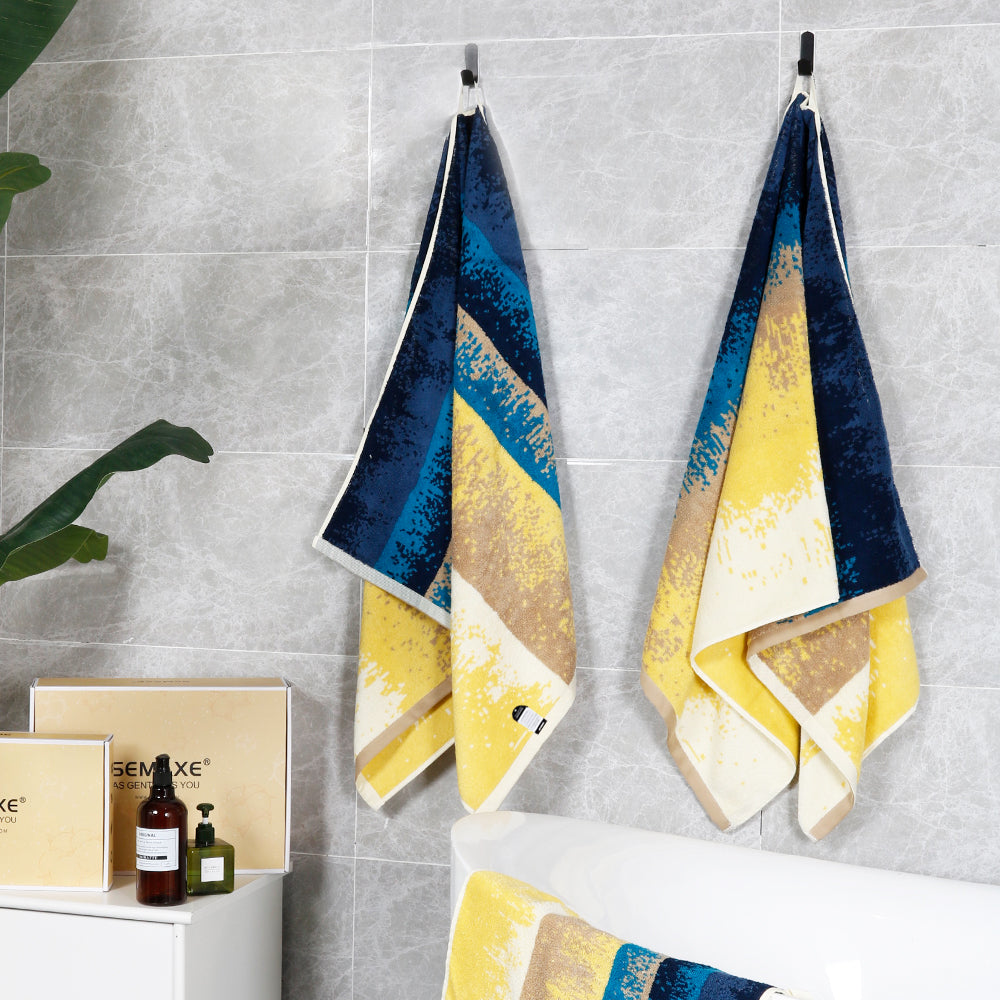 Bath towels from the Beach collection hang on the walls of modern bathrooms, revealing their unique yellow to blue pattern