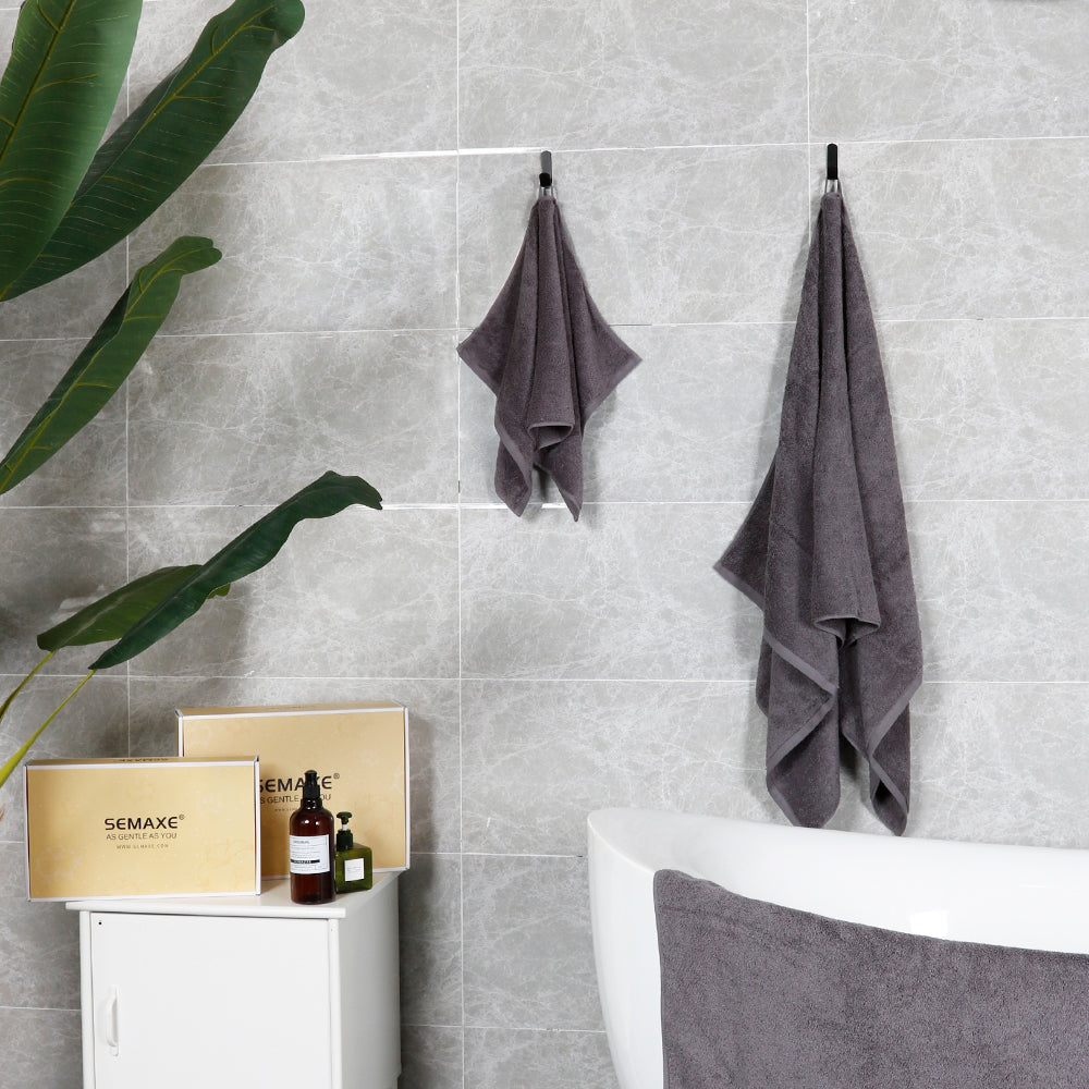 Gray towels are hung on the walls of modern bathrooms