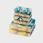 SEMAXE Impression 8-Piece Towel Set, complete with two bath towels, two hand towels, and four washcloths, featuring bold geometric patterns in cool greys and blues.