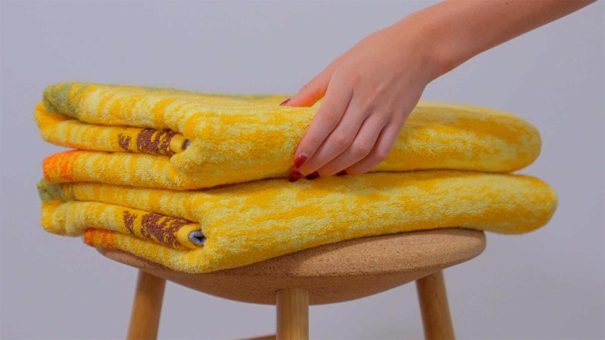 Two bath towels were placed on the stool, and the girl was about to take them to wrap her body