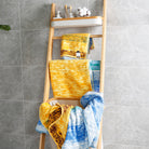 The "Wheat Field" series of towels and bath towels are placed on the shelves, showing their unique artistic patterns on the front and back